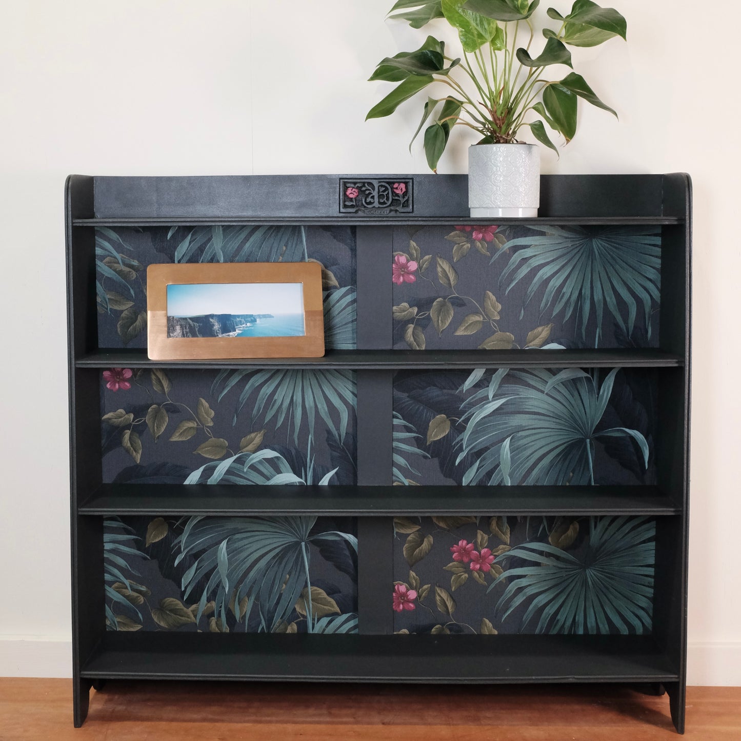 Mid-Century Modern Bookshelf with Tropical Wallpaper Back